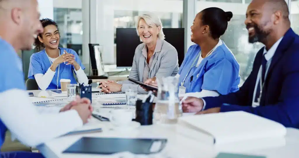 Boardroom, collaboration and healthcare with hospital manager speaking to staff
